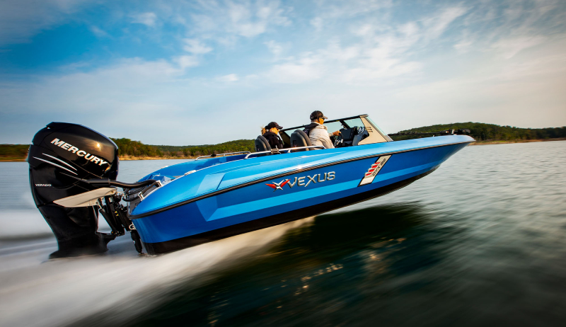 A person riding a 2021 Vexus AVX1980cc through a lake surrounded by trees.
